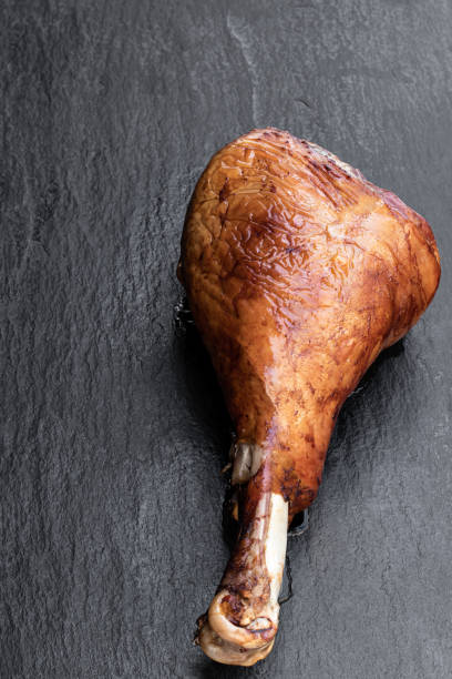 istock Roasted turkey leg on black stone background 1223594363