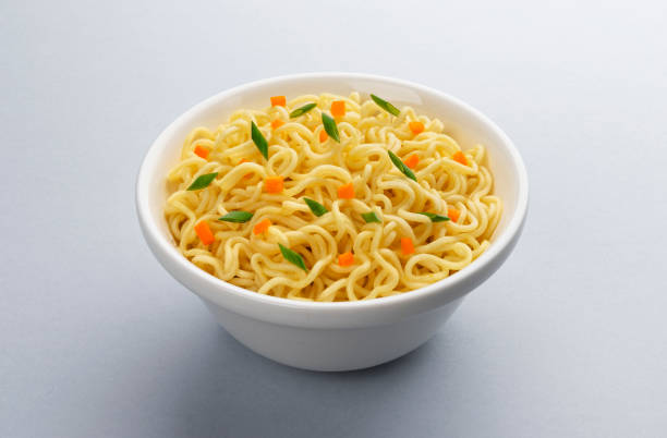 istock Instant noodles with vegetables and herbs isolated on white background 1223594550