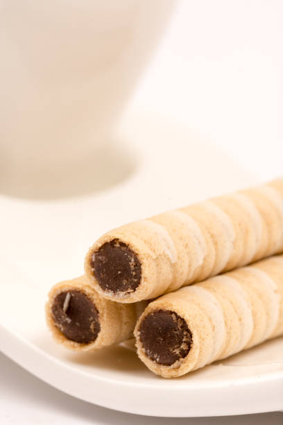 istock Wafer chocolate cream rolls on the plate of coffee 1223595194