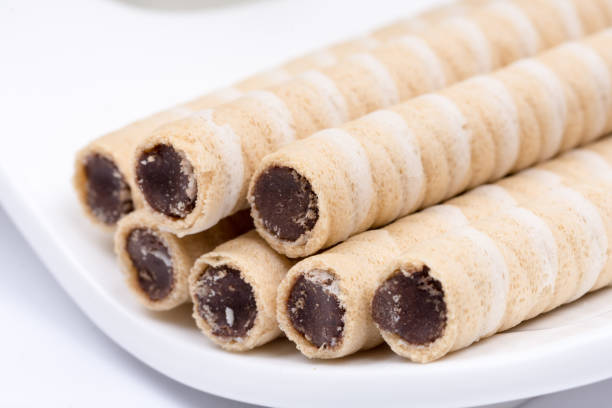 istock Wafer chocolate cream rolls on the plate 1223595227