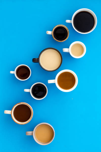istock Lots of coffee on blue desk top-down 1223596585