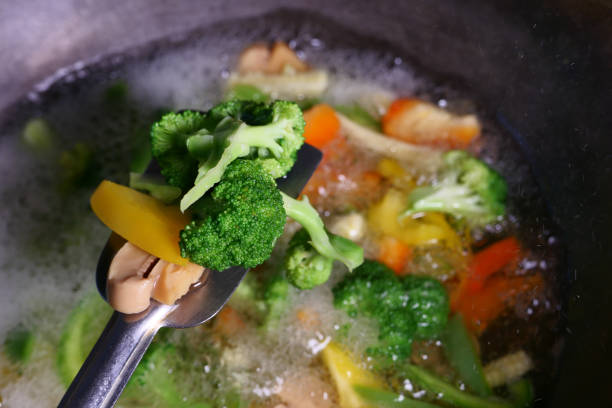 istock man cooking fried vegetables, close up 1223597271