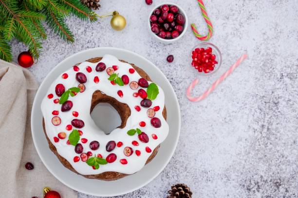 istock Chocolate cake Christmas wreath with sugar icing, cranberries, pomegranate and mint leaves on top. Festive Dessert for Christmas and New Year. 1223597320