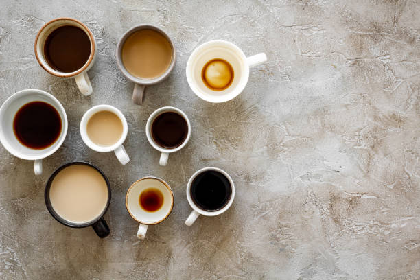 istock Coffee addiction. Many of cups on hrey table top view space for text 1223597392