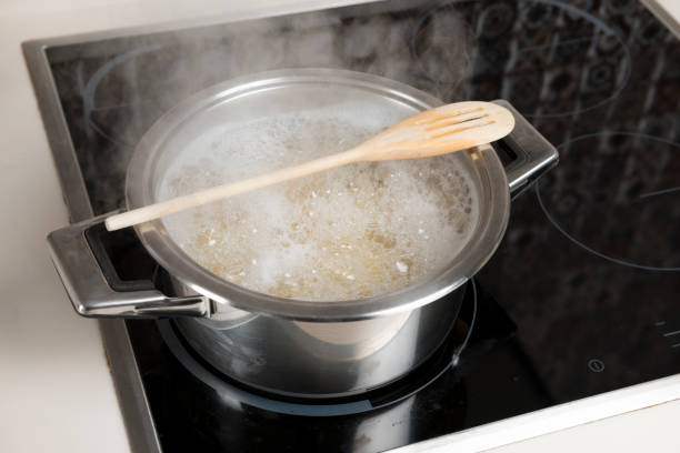 Life Hack Rest A Wooden Spoon Across The Top Of A Pot Of Boiling Water To Prevent  Overflow Stock Photo - Download Image Now - iStock