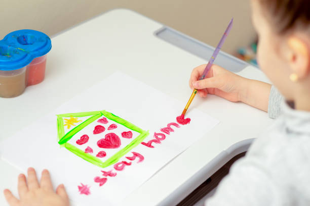 istock Child draws words Stay Home. 1223598236