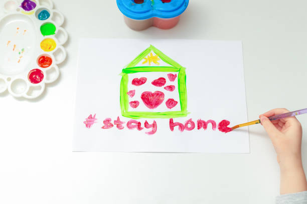 istock Child draws words Stay Home. 1223598241