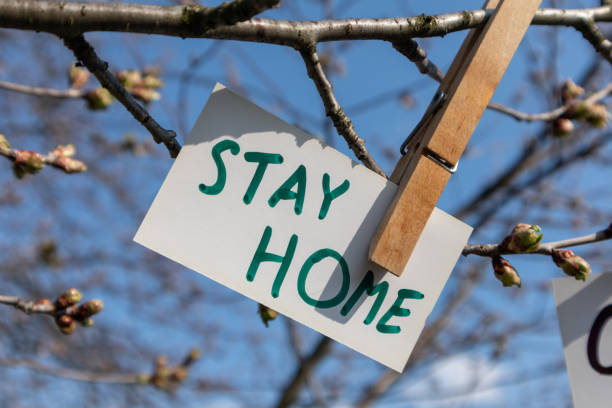 istock Stay home words on white card hanging pin spring 1223599778