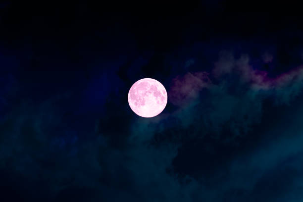Big full bright pink purple moon, colorful clouds