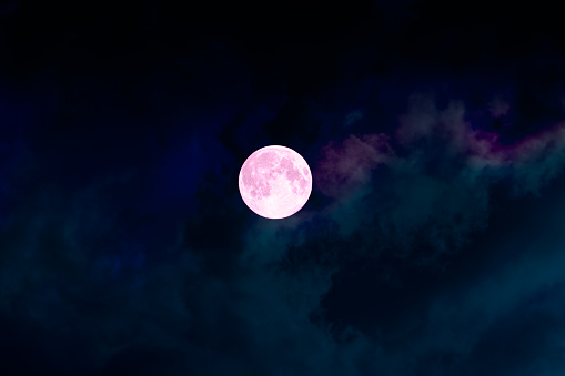 Big full bright pink purple moon, colorful clouds