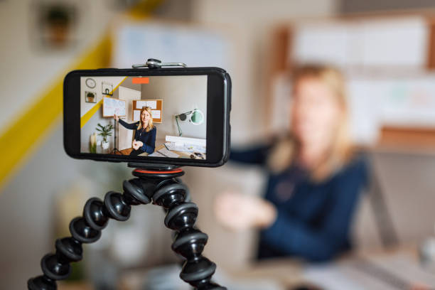 Math professor at home, looking and talking direct to camera during online classroom Mature smart professor holding online class for e-learning school kids and students professor business classroom computer stock pictures, royalty-free photos & images