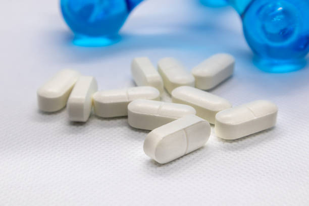 istock White long health drug pills on white background 1223603338