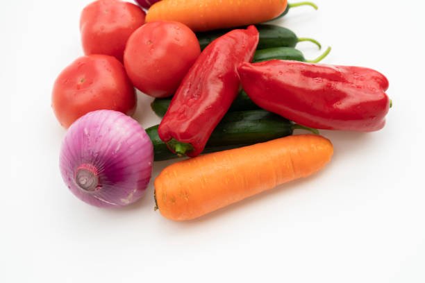A close-up of vegetable ingredients on a white background