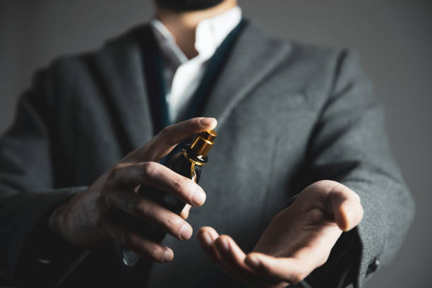 istock man hand bottle of perfume in hand 1223604039