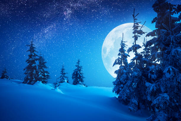 istock Full moon rising above the winter valley covered with fresh snow 1223604813