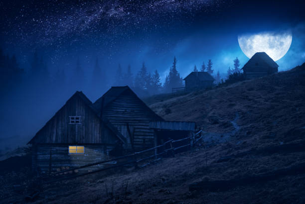 istock Full moon rising above the mountain village 1223605562