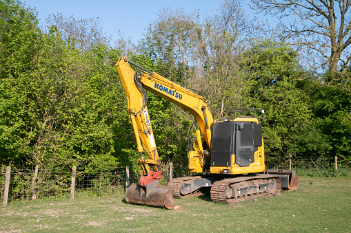 A Komatsu Excavator in Farningham, England. This farm falls on a public path within the Farningham Wood Nature Reserve