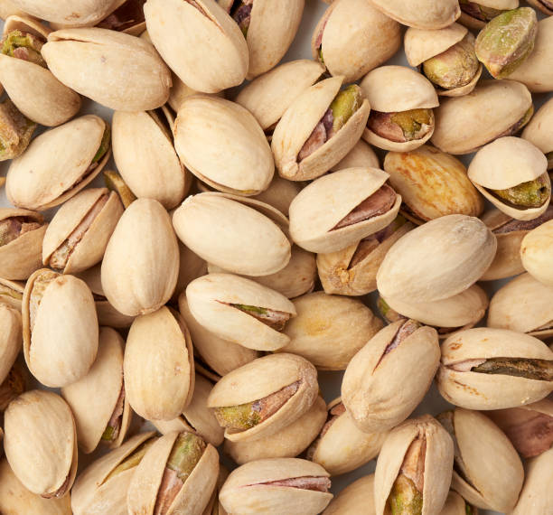 istock fried salted pistachios texture, top view 1223605946