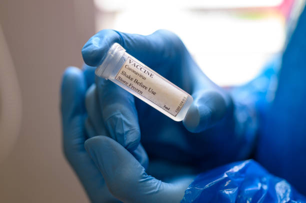 istock Laborant in protective gloves holding Coronavirus vaccine for Covid-19 1223606041