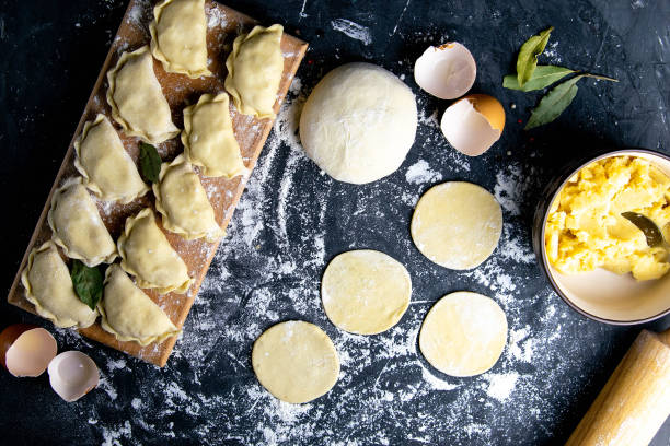 istock Raw dumpling. Preparation dumplings with potatoes. On dark rustic background. Top views, close-up 1223611158