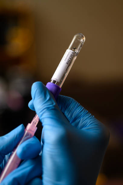 istock Hand in protective gloves fill syringe with Coronavirus vaccine for Covid-19 immunization 1223612501