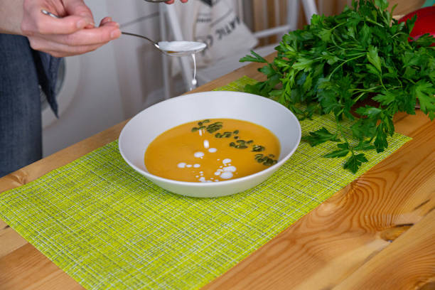 istock Preparing chicken stock with vegetables bouillon in a pot. Black chalkboard as background. 1223614126