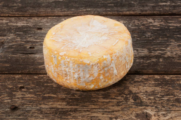 istock Camembert Cheese on Dark Wood 1223614146