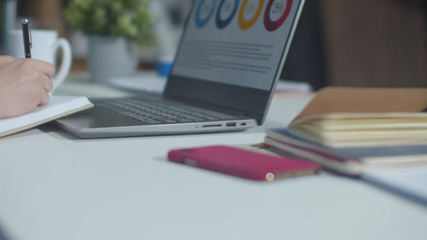 istock The secretary writes a note and works with the laptop 1223616330