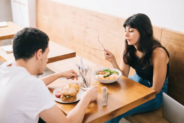 couple on a date, eating vegetarian food. - couple restaurant day south america imagens e fotografias de stock