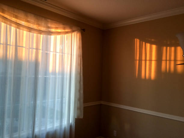 istock gold sunlight streams through curtains for golden design background 1223617251