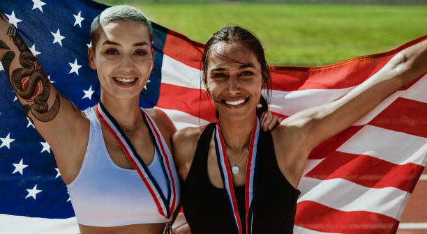 istock Two US athletes with national flag 1223619435