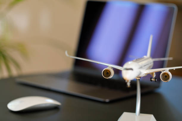 Airplane model and laptop on a table in a living room.