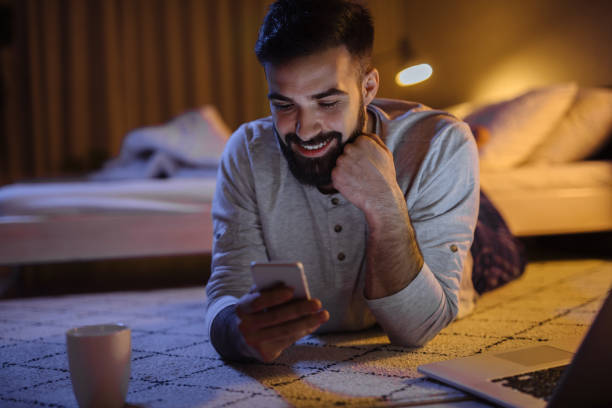 istock Handsome bearded man using phone in bedroom at night 1223619682