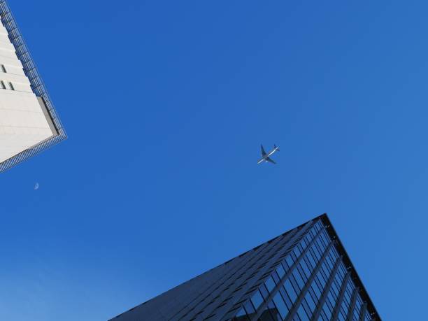 istock Passenger plane flying at low altitude over the building 1223620589