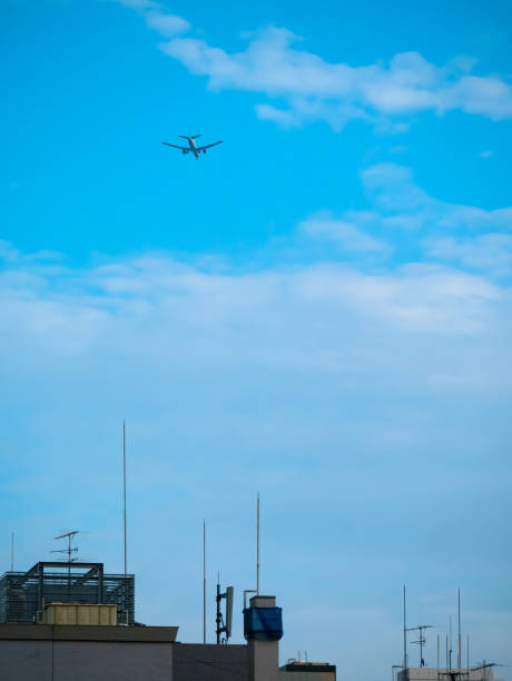 istock Passenger plane flying at low altitude over the building 1223620602