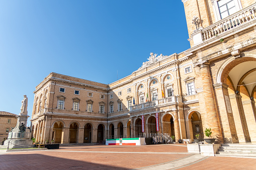Recanati, Marche, Italy, August 2019: Town Hall in Giacomo Leopardi Square with the monument dedicated to the poet, Recanati Town, Italy