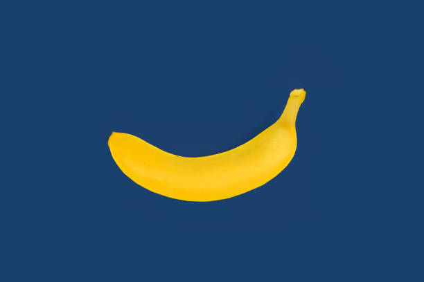 istock toy yellow plastic banana on blue colored background 1223624255