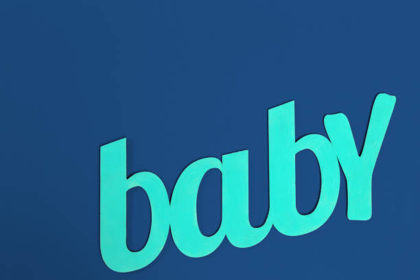 istock word BABY on classic blue background top view 1223624286