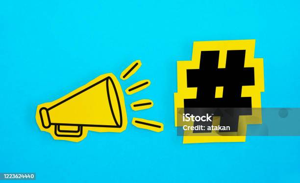 Megaphone Drawing On The Cut Yellow Paper Makes Hashtag Icon Announcement Stock Photo - Download Image Now