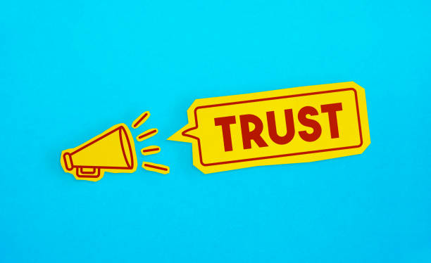 istock Megaphone drawing on the cut yellow paper makes “Trust” announcement. 1223625389