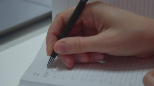 istock Accountant writes in a notebook and works on a laptop 1223625391