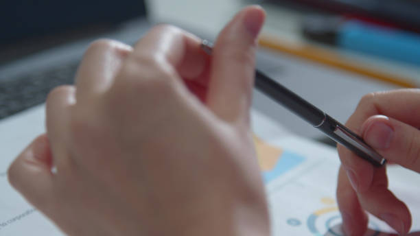 istock The secretary twists a pen in her hands. Close-up 1223625820