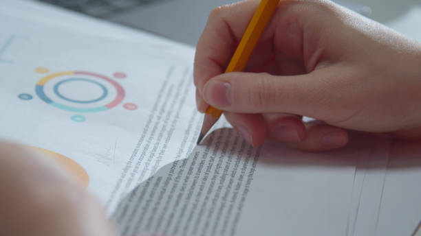 istock Woman corrects errors in the report with a pencil 1223627434