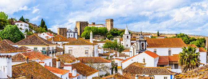 Obidos, Portugal: Old town skyline with house roof tops, church towers and the wall of the medieval castle located in the civil parish of Santa Maria, São Pedro e Sobral da Lagoa, a municipality in Oeste region.