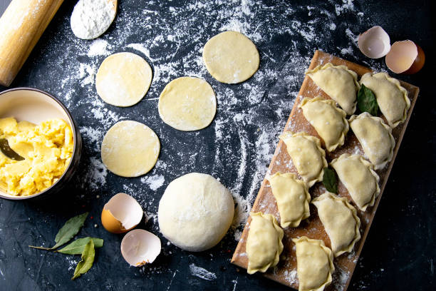 istock Raw dumpling. Preparation dumplings with potatoes. On dark rustic background. Top views, close-up 1223627773