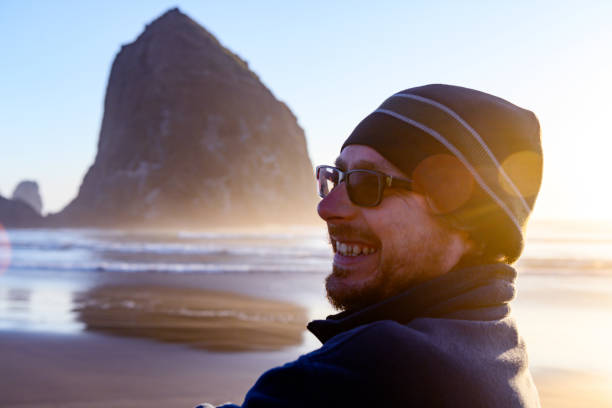 istock Real Man at Canon Beach Oregon on Autumn Vacation Walking Past Haystack Rock 1223629499
