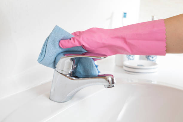 istock cleaning the faucet with blue cloth 1223631260