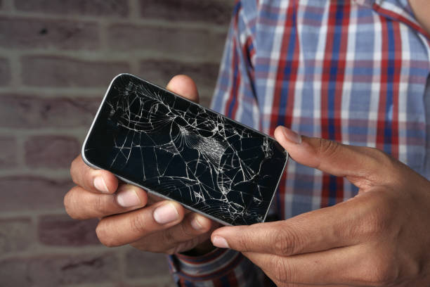 istock Close up of man hand holding broken smart phone 1223633389