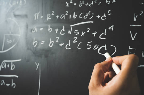 istock Education background concept. Close up male hand writing mathematical formula on chalkboard. 1223635462