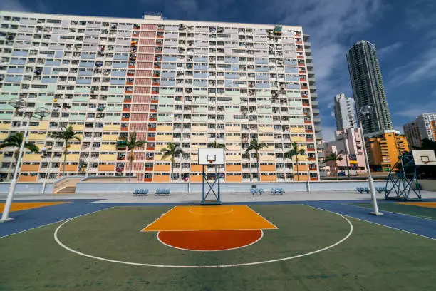 Photo of Colorful basketball court and buildings in Hong Kong residential district
